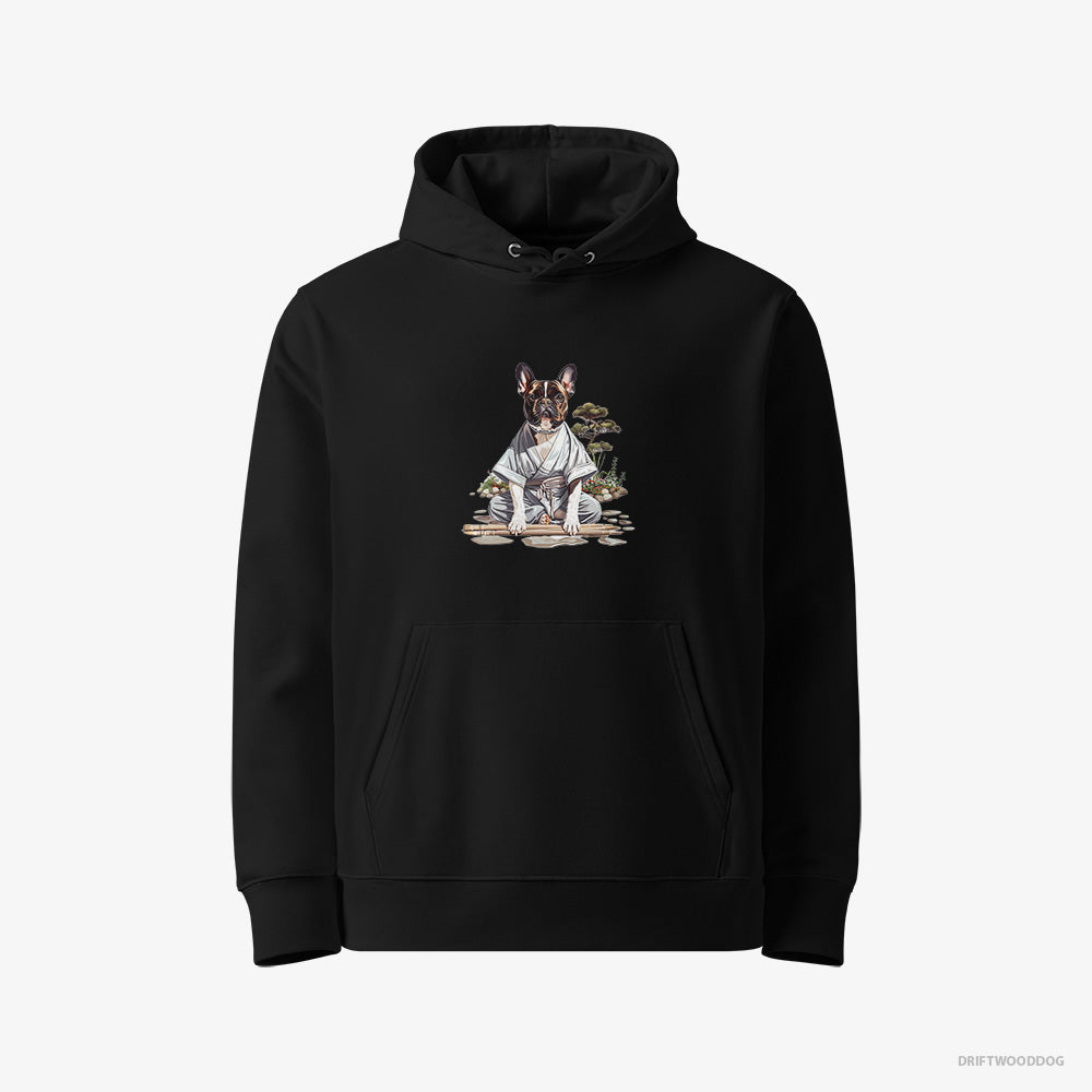 French Bulldog Hoodie – Women Black Hoodie Eco-Friendly – in a Ninja Cloak Among Garden Paths (on White Background)